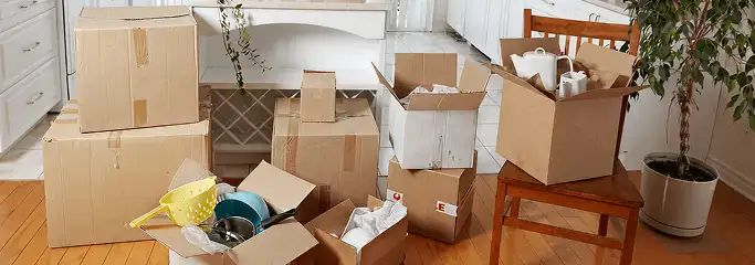 Packed moving boxes and household items in a kitchen before move-out or move-in cleaning, Norfolk, VA.